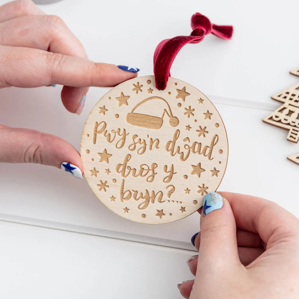 Pwy Sy'n Dwad Dros y Bryn Wooden Welsh Language Christmas Decoration from Draenog for sale at Mostyn