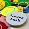 Feeling Lush Smilie Face Neon Yellow Leather Key Fob 2 from ARK Colour Design for sale at Mostyn