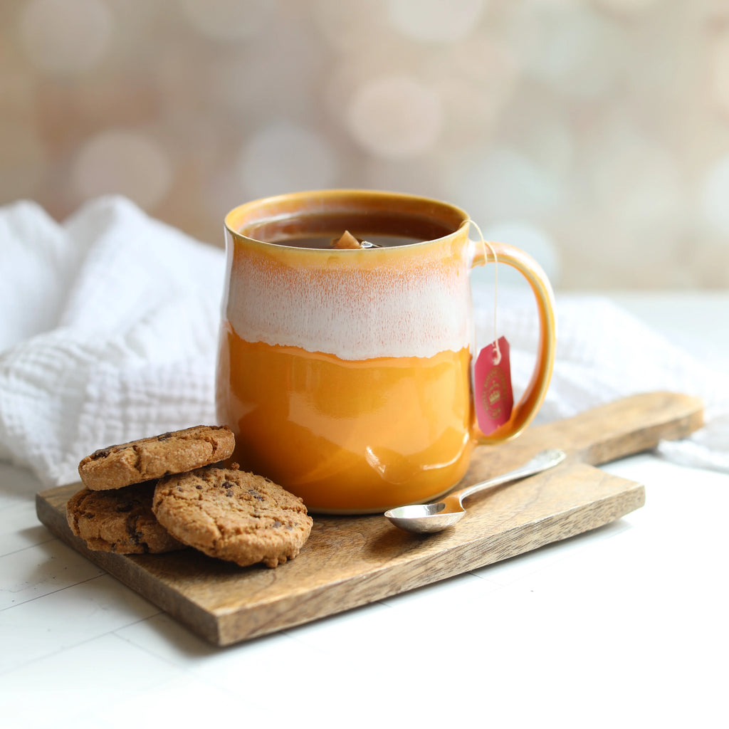 A Mustard Yellow Handmade Ceramic Mug from Glosters pottery for sale at Mostyn.