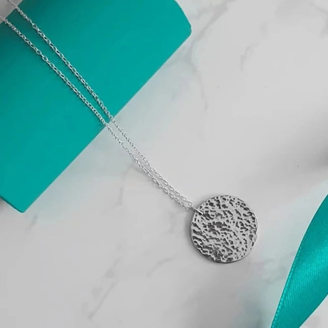 A Handcrafted Hammered Disc Eco-Silver Pendant Necklace from Jewellery by Jackie for sale at Mostyn.