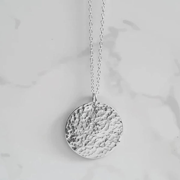 A Handcrafted Hammered Disc Eco-Silver Pendant Necklace from Jewellery by Jackie for sale at Mostyn.