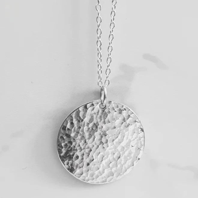 A Handcrafted Hammered Disc Eco-Silver Pendant Necklace from Jewellery by Jackie for sale at Mostyn.