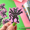 A Pink Winged Devil Vinyl Sticker by Stacey Mcvoy Caunt for sale at Mostyn