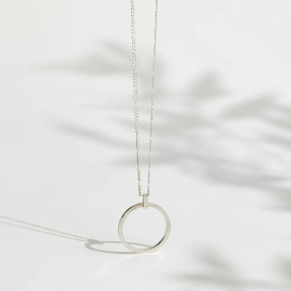 Sterling Silver Sparkle Effect Circle Necklace on an 18" Figaro Chain from Rebecca Oldfield for sale at Mostyn