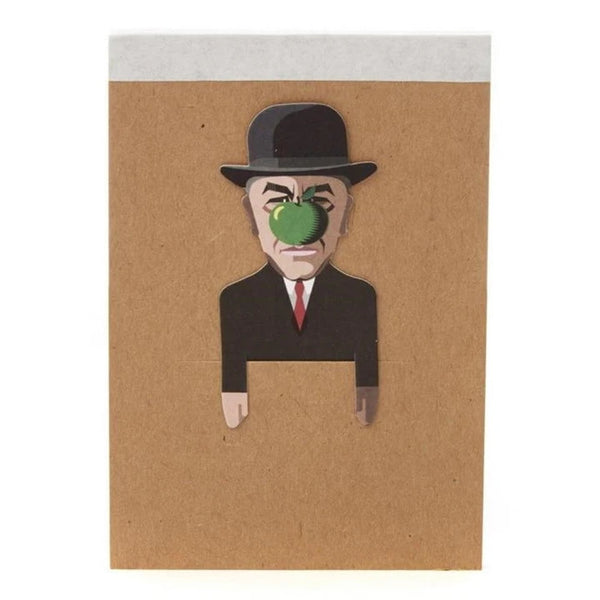 Surrealist artist sketchbook. Brown kraft card background with artist wearing a suit and black bowler hat, with a green apple in front of his face. Made by Noodoll