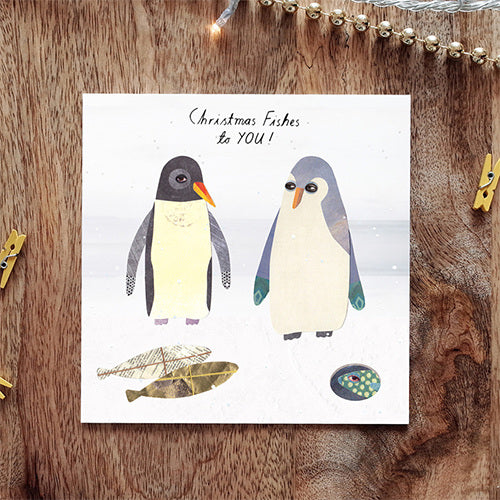 Collage style illustration showing two penguins with fish shaped presents wrapped in front of them. The text above them says 'Christmas fishes to you!'