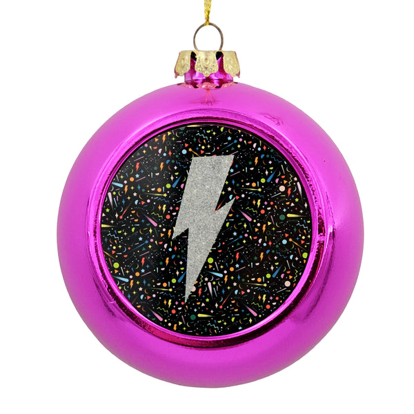 Metallic bauble with a printed disc on the front. The disc has a graphic illustration of an lightning bolt. 
