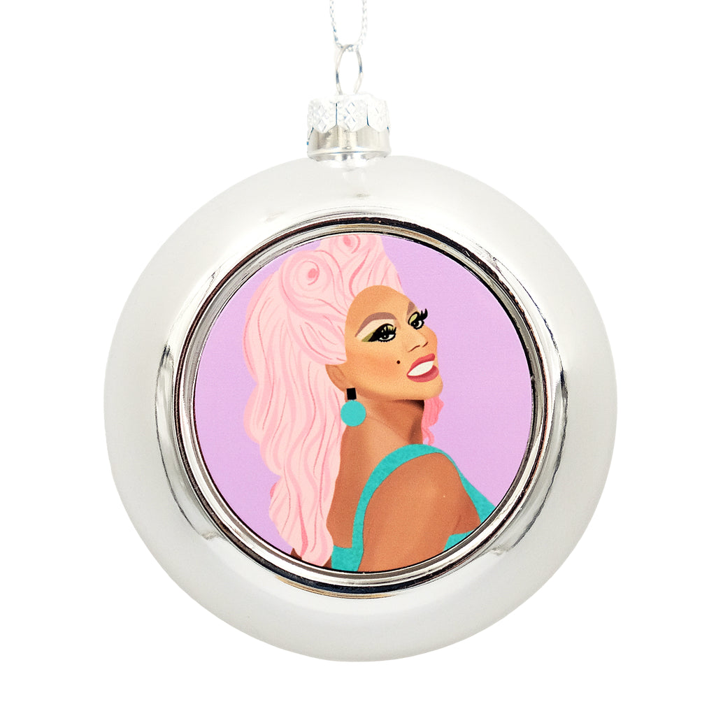 Metallic Silver bauble with a printed disc on the front. The disc shows an illustration of RuPaul