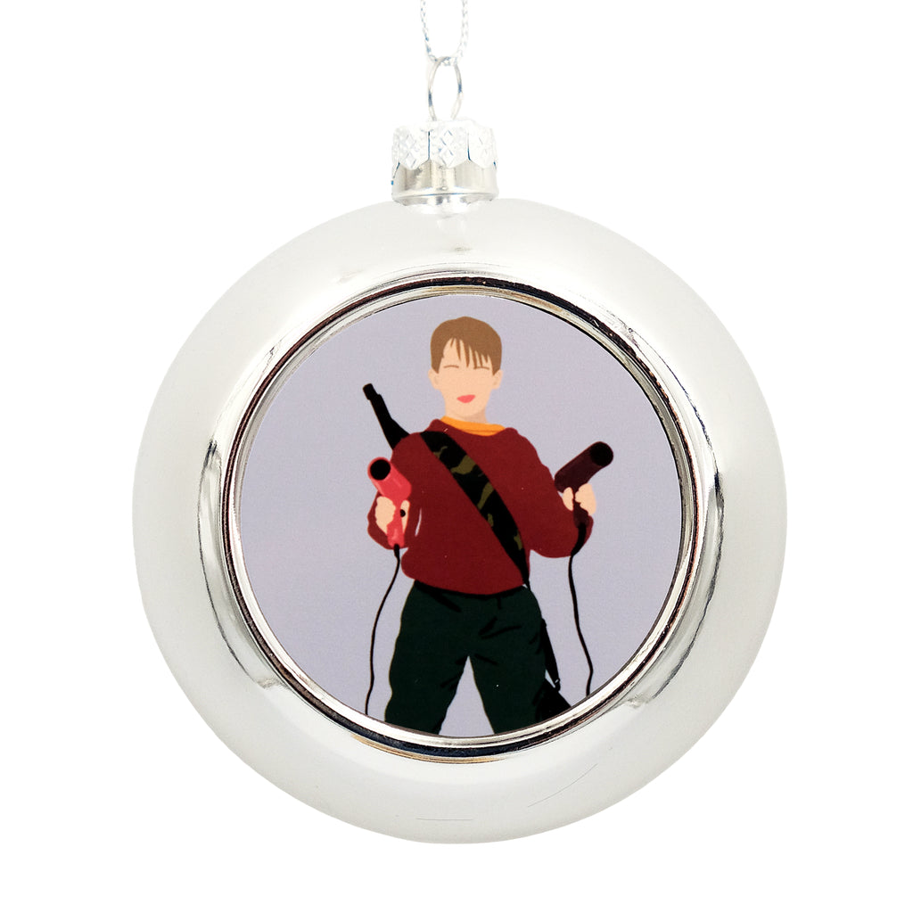 Metallic silver bauble with a printed disc on the front. The disc has a graphic illustration of Kevin Kevin McCallister from Home Alone.