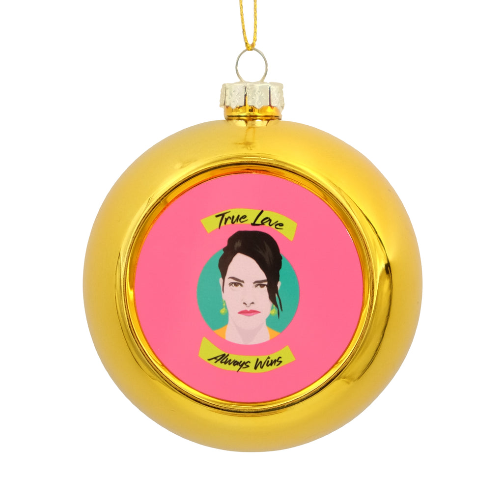 Metallic Gold Bauble with a printed disc on the front showing an illustration of Tracey Emin, with the text 'True Love Always Wins'. 