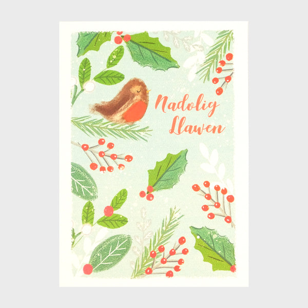Watercolour and digital illustration on shimmering Pearlescent background. Various winter greenery and berries with snow falling in the background and a small robin perched on a fir branch