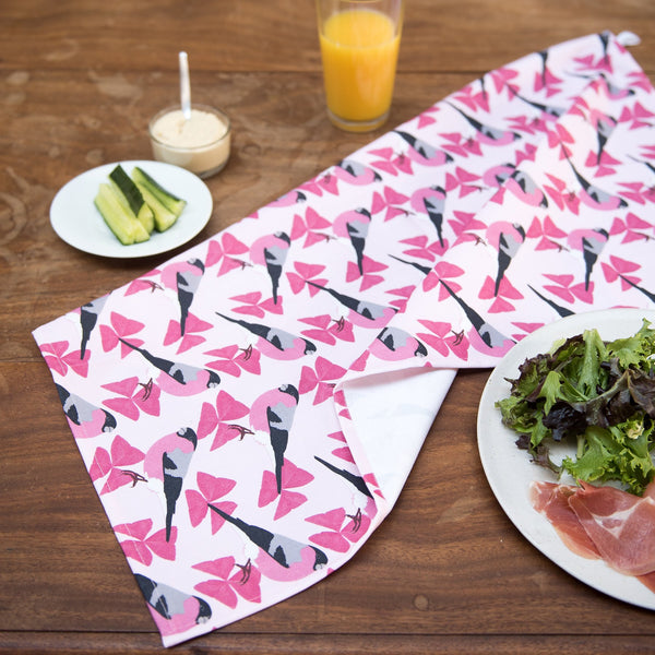 Lifestyle image.  Pink patterned fabric print with bullfinch motif.