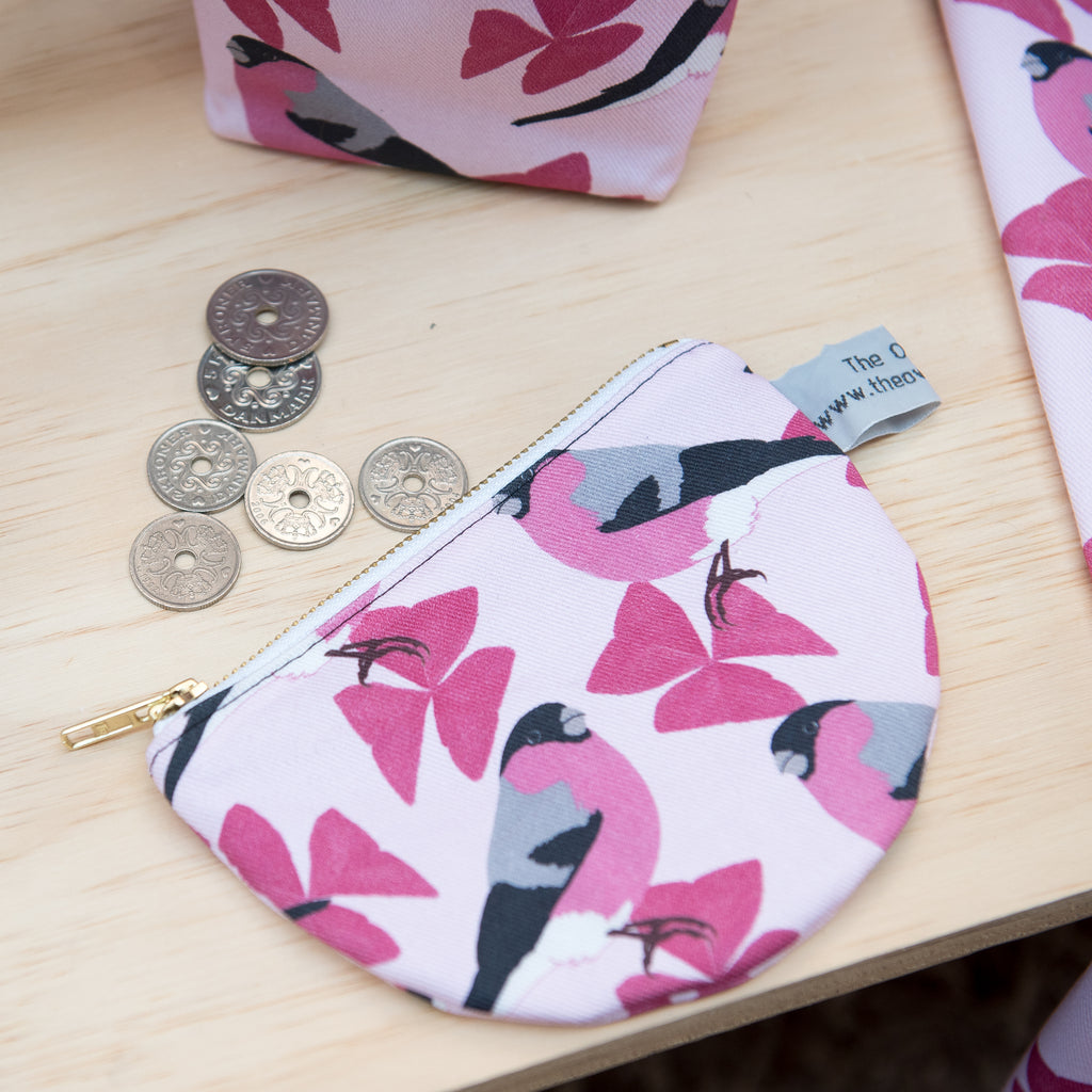 Lifestyle image.  Pink patterned fabric with bullfinch motif.