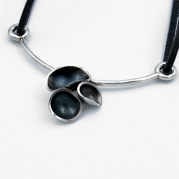 Necklace detail - silver and oxidised silver with 'mussel' shaped feature, leather thong fastening. Made by Clarrie Flavell.