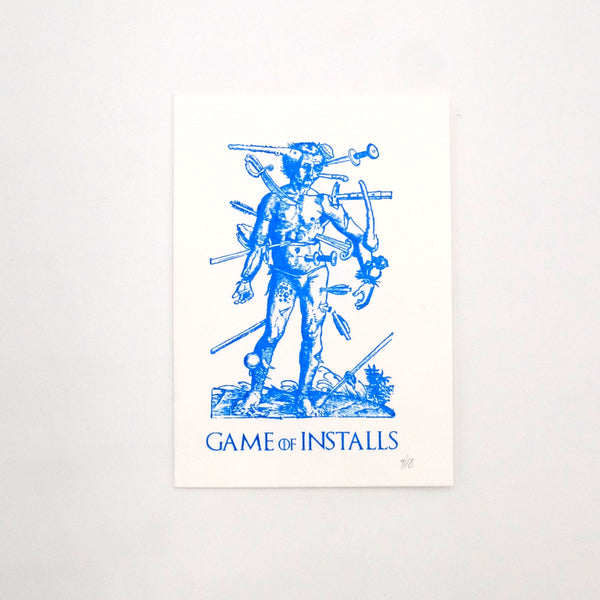 Hand printed 'Game of installs' blue and white print. Man with numerous tools stuck into his body. Made by Mark Hughes