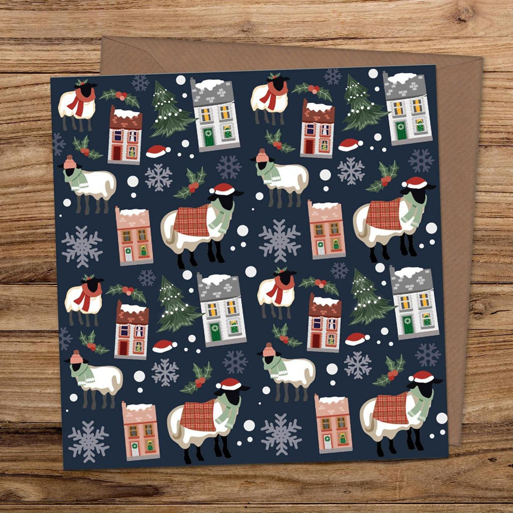 Illustrated Christmas card with a navy background sheep wearing scarves and santa hats, snowflakes, christmas trees and snow covered houses