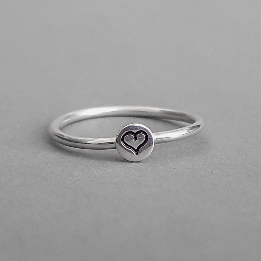 Product image.  Sterling silver stacking ring with heart motif.