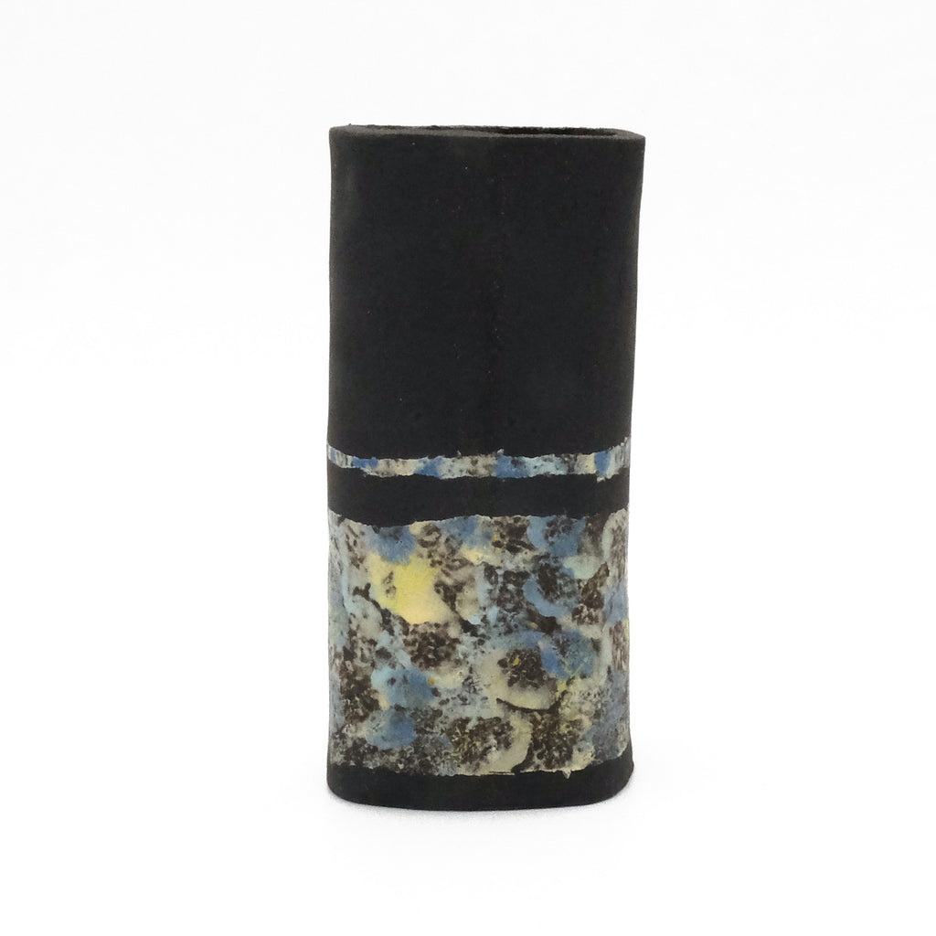 Image of a ceramic vessel: black with abstract design.