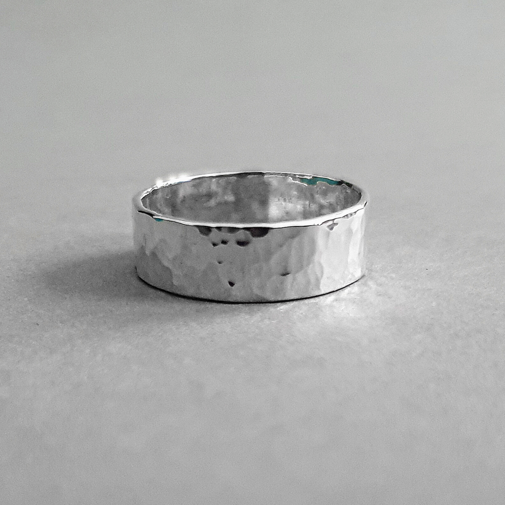 Product image.  Sustainable hammered silver band ring.