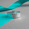 Product image with ribbon.  Sustainable hammered silver band ring.