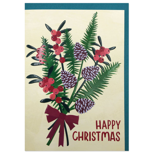 Christmas card - pale cream background. 'Happy Christmas' in deep burgundy. Spray of winter foliage, pine cones and berries tied with a deep burgundy ribbon. 