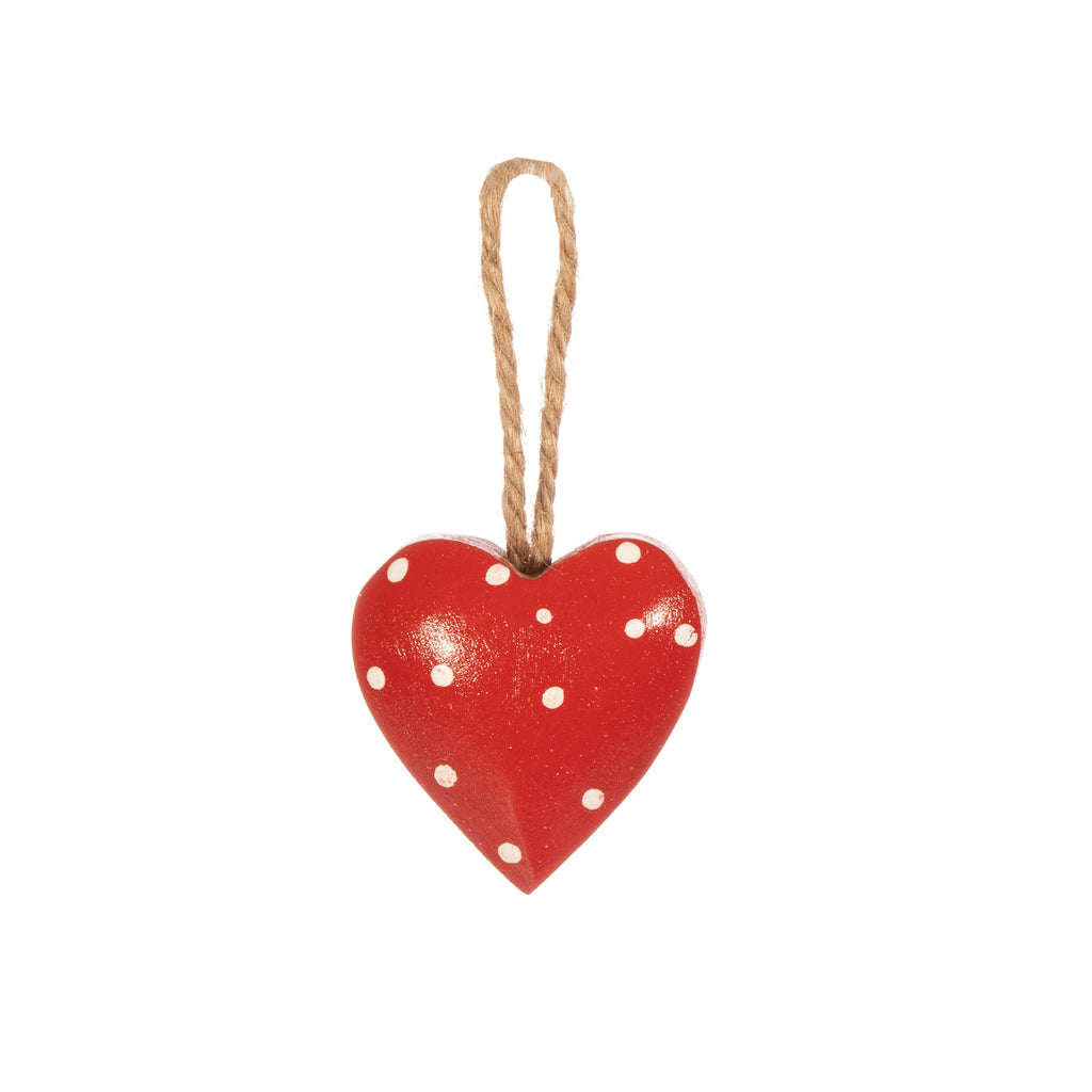 Crafted from mango wood this painted heart decoration features polka dots and hangs from yarn string.