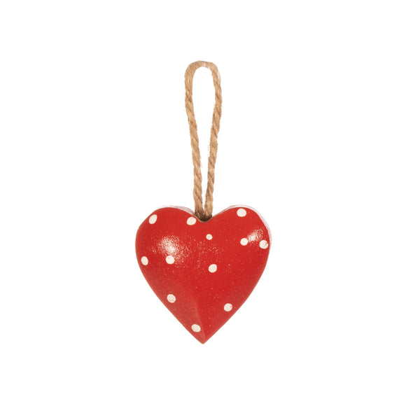 Crafted from mango wood this painted heart decoration features polka dots and hangs from yarn string.
