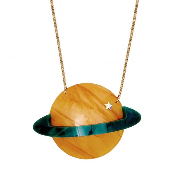 Necklace. Laser-cut marble style acrylic in dark green and amber-colour, saturn like planet with mirrored silver star. Hanging on antique gold chain. Made by Tatty Devine