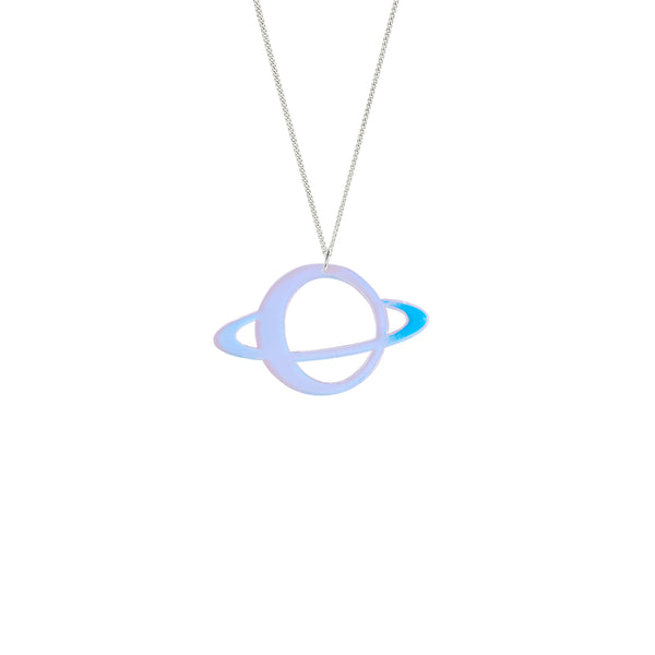 A chain necklace with an acrylic laser-cut planet design, shown against a white background. The laser-cut planet is an outline of a circle with a hollow centre. It has a ring circling it horizontally around the middle. The colour of the planet is an iridescent pale blue / lilac. The colour of the chain is silver. The planet-shaped detail is attached to the chain from the top middle section of the circle so that the chain hangs in a v-shape. Made by Tatty Devine.