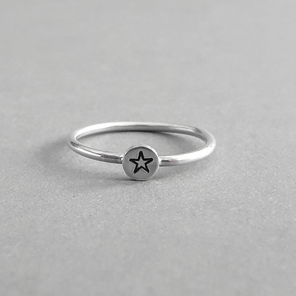 Product image.  Sterling silver stacking ring with star motif.
