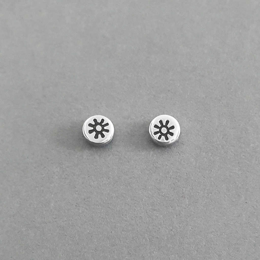 Product image.  Small sterling silver stud earrings with sun motif.